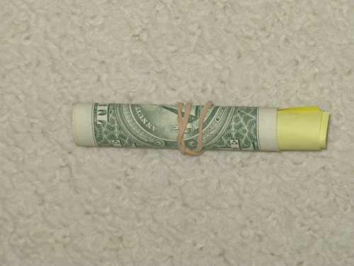 A dollar bill waiting to be hidden. A small step to financial wealth. Leave 1 Dollar.